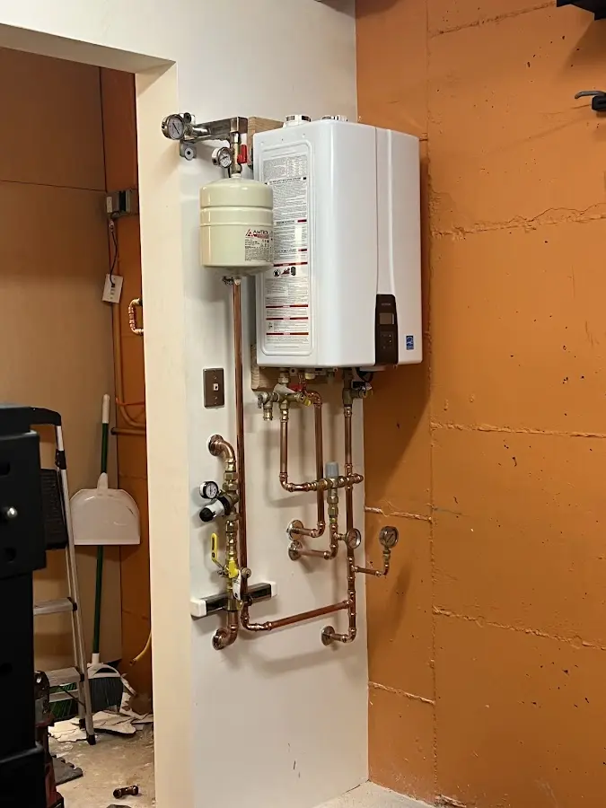 Plumbing technician inspecting water heater connections in Wauchula